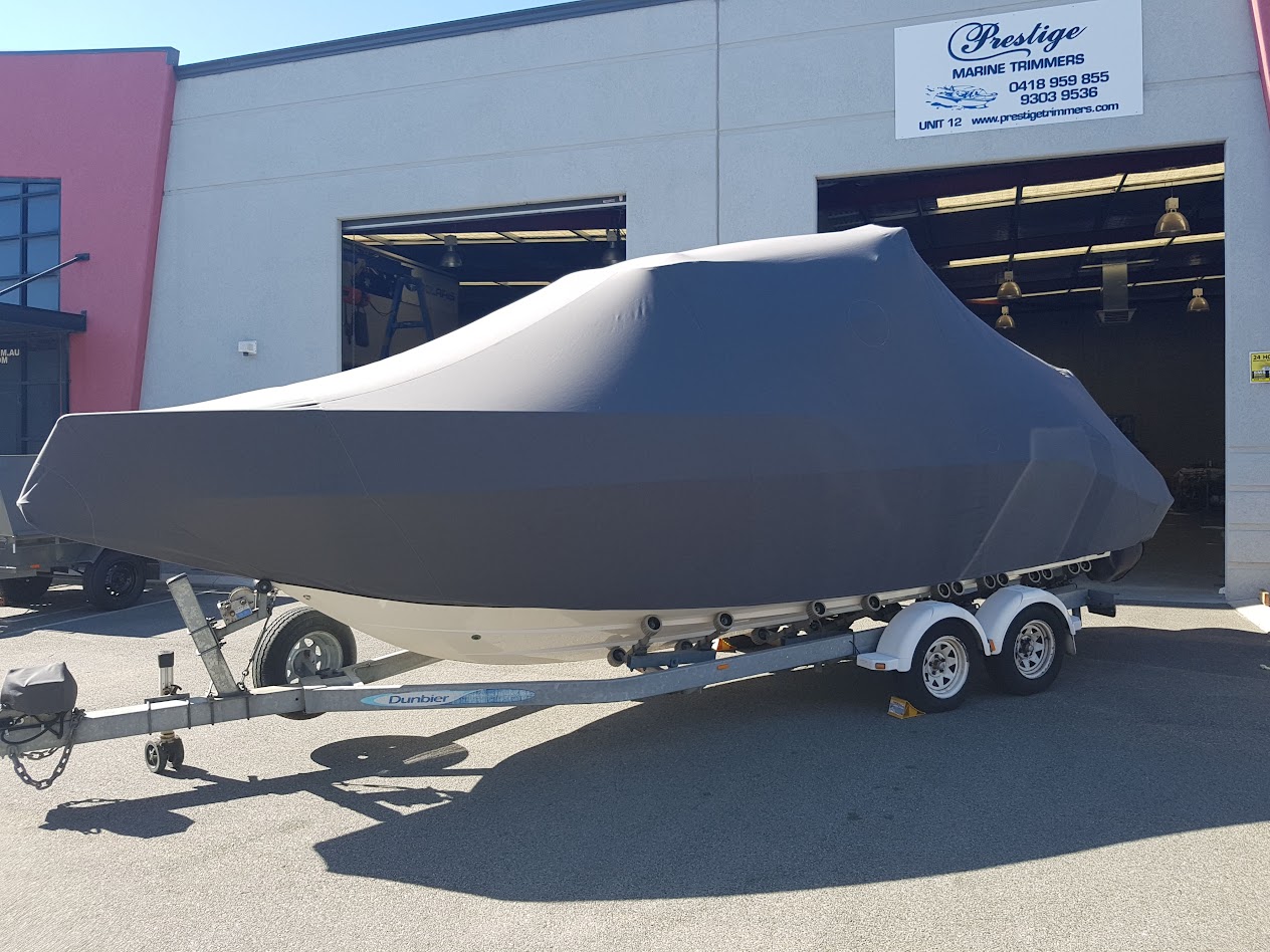 Custom-made full boat cover fitted over the deck and console of a trailer boat